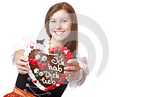 Woman in Oktoberfest dirndl holds heart