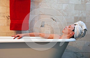 Woman in old fashion clawfoot tub