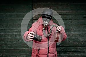 Woman with old gas mask takes a selfie with a mobile phone. Concept - Nuclear Disarmament and Radiation Protection, epidemic,