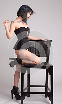 Woman in One Piece Leaning on Chair