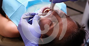 A woman with an open mouth in the dental procedure