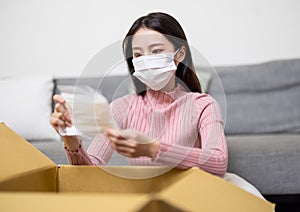 Woman open online shopping parcel