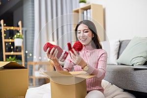 Woman open online shopping parcel