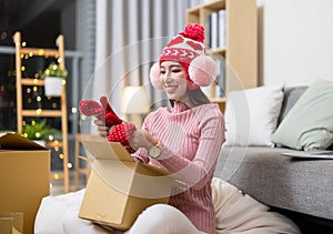 Woman open online shopping parcel