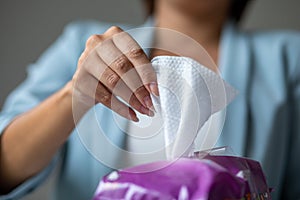 Woman open package of wet wipes to cleaning hands