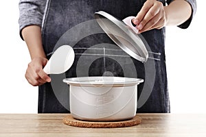 Woman open rice pot on white background