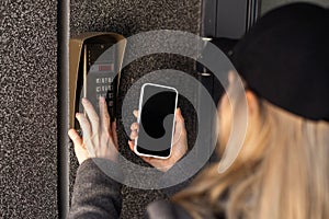 woman open the safety door with smart phone