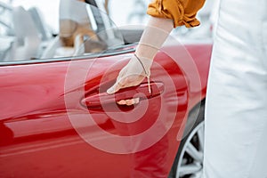 Woman opening a car door