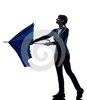 Woman opening closing umbrella silhouette