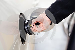 Woman opening diesel fuel cap