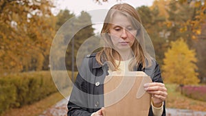 Woman opening a disposable lunch box