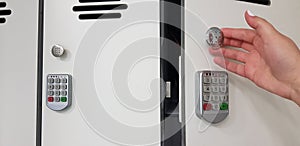 Woman opening a door of security white locker with electric code locks