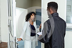 Woman Opening Door To Bailiff