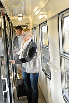 Woman opening the door of train compartment