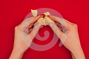 Woman opening fortune cookie, Chinese New Year concept