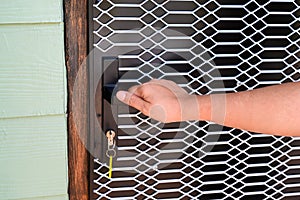 Woman opening the front door to go inside the house