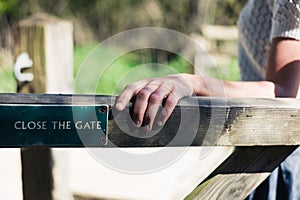 Woman opening gate in forest