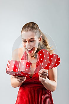 Woman opening the gift and is happy