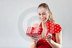 Woman opening the gift and is happy