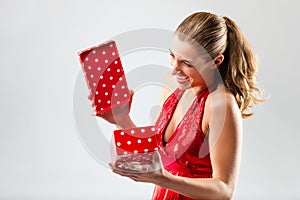 Woman opening the gift and is happy