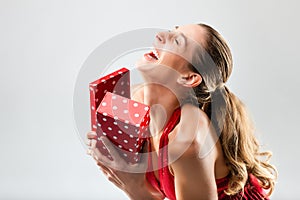 Woman opening the gift and is happy