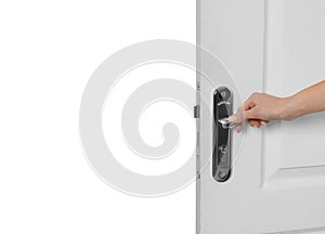 Woman opening light wooden door on white, closeup view