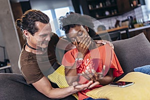 Woman opening a present her boyfriend bought her for their anniversary