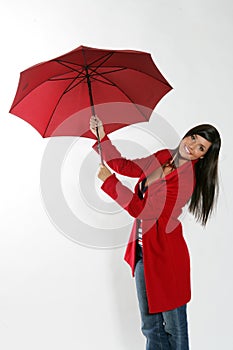 Woman opening red umbrella.