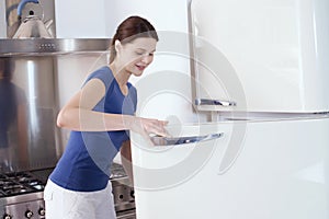 Woman opening the refrigerator