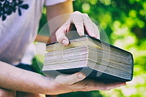 Woman opens a big old book