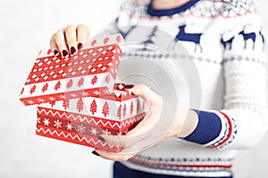 Woman opens a box of gifts