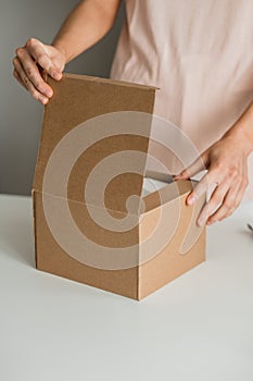 Woman opens a cardboard box