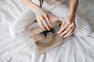 A woman opens a cardboard box