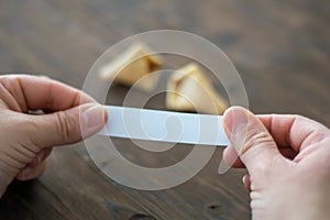 Woman opens a fortune cookie