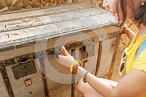 Woman opens an old pirate chest in fortress