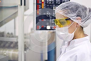 Woman Operating The Control Panel - Pharmaceutical Manufacturing photo