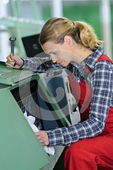 Woman operating machine with tools