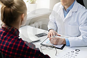 Woman at ophthalmologist visit in clinics office photo