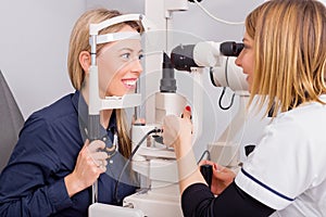 Woman in optometrists office checking her vision