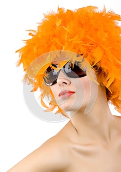 Woman with orange feather wig and sunglasses