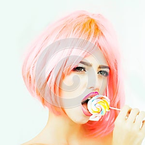 Woman with orange hair lick lollipop