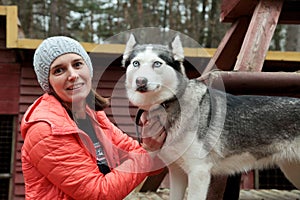 Woman playing with huskie