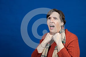 Woman in orange sweater in studio photo