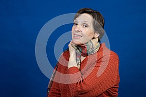 Woman in orange sweater in studio photo