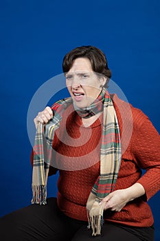 Woman in orange sweater in studio photo