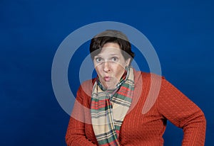 Woman in orange sweater in studio photo