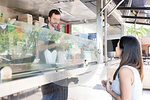 Woman ordering food in a truck