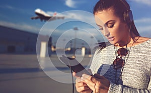 Woman ordering ticket by tablet on airport