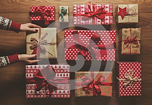 Woman organising beautifully wrapped vintage christmas presents, image with haze, view from above photo