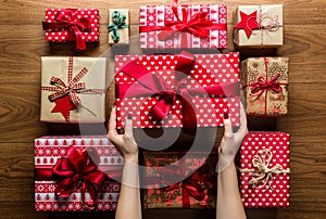 Woman organising beautifully wrapped vintage christmas presents, view from above